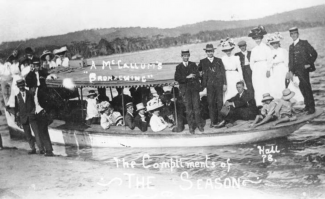 historic photo of people boarding a small ferry